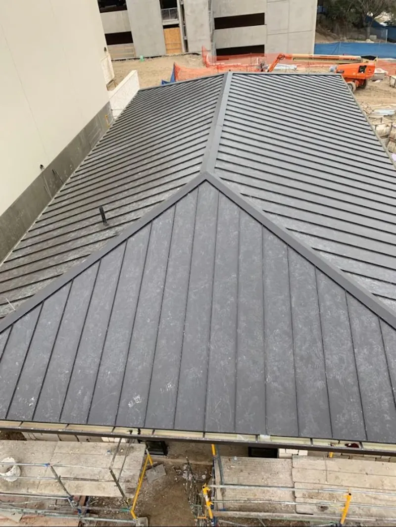 Commercial metal roof construction with crane equipment in Sun Prairie