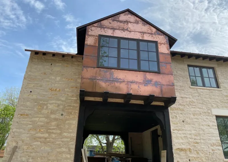 Copper metal panel facade on a stone building for Skylight Installation in Sun Prairie