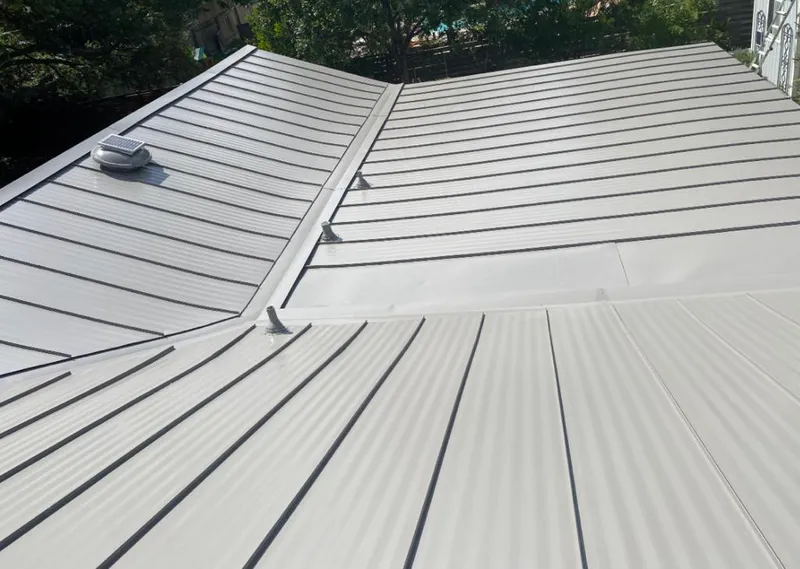Solar attic fan installed on a metal roof for Roof Ventilation in Sun Prairie